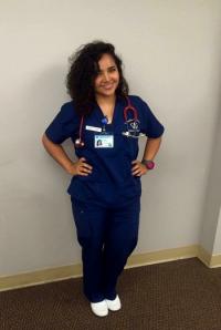 Columbia Nursing female student in nursing scrubs.